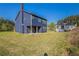 Expansive backyard featuring green lawn, covered porch, and view of the neighborhood, ideal for Gathering gatherings at 417 Flowery Branch Ct, Villa Rica, GA 30180
