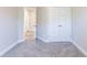 Bedroom with carpet, neutral walls, closet, and ample space at 417 Flowery Branch Ct, Villa Rica, GA 30180