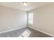 Carpeted bedroom with one window and neutral color walls at 417 Flowery Branch Ct, Villa Rica, GA 30180