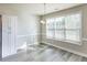 Bright dining area with large windows, laminate flooring, and modern chandelier at 417 Flowery Branch Ct, Villa Rica, GA 30180