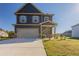 Charming two-story home featuring a two-car garage and a welcoming front porch at 417 Flowery Branch Ct, Villa Rica, GA 30180