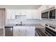 Beautiful kitchen showcases white cabinets, stainless appliances, and granite countertops at 417 Flowery Branch Ct, Villa Rica, GA 30180