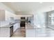 Bright kitchen featuring white cabinetry, granite countertops, and stainless steel appliances at 417 Flowery Branch Ct, Villa Rica, GA 30180