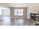 Inviting living room featuring a stone fireplace, laminate flooring and bright, large windows at 417 Flowery Branch Ct, Villa Rica, GA 30180