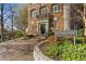 Exterior view of brick condominium building with a brick driveway and manicured landscaping at 1 S Prado Ne # 15, Atlanta, GA 30309