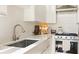 Close up of a modern kitchen featuring sleek countertops, a stainless steel sink and a contemporary stovetop at 1 S Prado Ne # 15, Atlanta, GA 30309