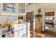 Modern kitchenette with white cabinets, stainless steel appliances and a view into the bedroom at 1 S Prado Ne # 15, Atlanta, GA 30309
