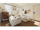 Bright living room features a white sectional couch, natural light, and hardwood floors at 1 S Prado Ne # 15, Atlanta, GA 30309
