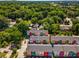 Aerial view of colorful townhomes nestled within a green, wooded neighborhood at 140 Color Cir, Atlanta, GA 30317
