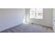 Cozy bedroom featuring neutral carpeting, bright light from the window, and white trim at 140 Color Cir, Atlanta, GA 30317