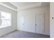 Bright bedroom with neutral carpet, tray ceiling, and white trim with two closets at 140 Color Cir, Atlanta, GA 30317