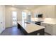 Modern kitchen features white cabinets, stainless steel appliances, and a spacious island with sink at 140 Color Cir, Atlanta, GA 30317