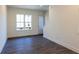 Inviting living room with wood-look floors and a view into the kitchen and stairs to the second floor at 140 Color Cir, Atlanta, GA 30317