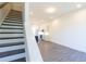 View of modern living area with stairs, recessed lighting, and view into modern kitchen at 140 Color Cir, Atlanta, GA 30317