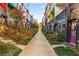 Colorful townhomes line a walkway with manicured landscaping and vibrant curb appeal at 140 Color Cir, Atlanta, GA 30317
