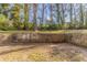 Large backyard with a retaining wall and mature trees at 3475 Glensford Dr, Decatur, GA 30032