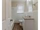 Bathroom featuring modern vanity, window, toilet, and tile walls at 3475 Glensford Dr, Decatur, GA 30032