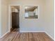 Dining area with wood floors offers a view to the modern kitchen and stainless steel refrigerator at 3475 Glensford Dr, Decatur, GA 30032