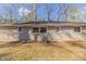 Rear exterior view of a single-story brick home with backyard at 3475 Glensford Dr, Decatur, GA 30032