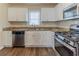 Bright kitchen with white cabinets, stainless steel appliances, granite countertops, and wood flooring at 3475 Glensford Dr, Decatur, GA 30032