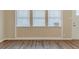 Bright living room featuring wood floors, neutral paint, and natural light from the window at 3475 Glensford Dr, Decatur, GA 30032