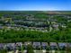 Aerial view showcases a residential neighborhood with lush green trees at 1218 Lanier Springs Dr, Buford, GA 30518
