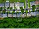 An aerial view of a home on a +/- 0.22 acre lot, surrounded by lush greenery at 1218 Lanier Springs Dr, Buford, GA 30518