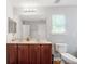 This bathroom features a double sink vanity with a large mirror and wood cabinets at 1218 Lanier Springs Dr, Buford, GA 30518