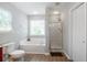 This bathroom has a tub, shower, wood floors and a large window for plenty of natural light at 1218 Lanier Springs Dr, Buford, GA 30518