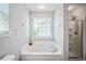 This bathroom has a luxurious soaking tub and a glass enclosed shower area at 1218 Lanier Springs Dr, Buford, GA 30518