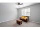Cozy bedroom featuring neutral carpet, fan, and a window providing natural light for a relaxing atmosphere at 1218 Lanier Springs Dr, Buford, GA 30518