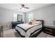 Bright bedroom featuring a ceiling fan, neutral walls, and black furniture at 1218 Lanier Springs Dr, Buford, GA 30518