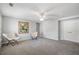 Expansive bonus room with two chairs, carpet flooring, and soft grey walls at 1218 Lanier Springs Dr, Buford, GA 30518