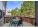 Outdoor wooden deck with a table and chairs, framed by lush trees for a private retreat feel at 1218 Lanier Springs Dr, Buford, GA 30518