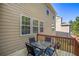 Outdoor wooden deck with a table and chairs, perfect for relaxing and private outdoor enjoyment at 1218 Lanier Springs Dr, Buford, GA 30518