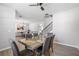 Dining area connecting to a living space, featuring modern furniture and ample lighting for enjoyable meals at 1218 Lanier Springs Dr, Buford, GA 30518