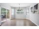 Elegant dining space with modern chandelier, hardwood floors, and sliding doors opening to a deck for outdoor dining at 1218 Lanier Springs Dr, Buford, GA 30518