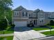 Beautiful two-story home with a well-kept lawn, enhanced by mature trees and an attached two-car garage at 1218 Lanier Springs Dr, Buford, GA 30518