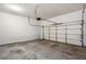 Spacious garage ready for customization, featuring a clean concrete floor and functional door for secure parking at 1218 Lanier Springs Dr, Buford, GA 30518