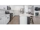 Modern kitchen featuring white cabinets, stainless steel appliances, and a stylish island, perfect for culinary enthusiasts at 1218 Lanier Springs Dr, Buford, GA 30518