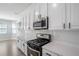 Well-appointed kitchen with stainless steel appliances, quartz countertops, and bright white cabinets at 1218 Lanier Springs Dr, Buford, GA 30518