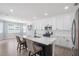 A spacious kitchen featuring a large island with seating, white cabinets, and stainless steel appliances at 1218 Lanier Springs Dr, Buford, GA 30518