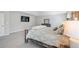 This primary bedroom features carpet floors, a TV, neutral paint and a window for natural light at 1218 Lanier Springs Dr, Buford, GA 30518
