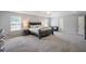 Large main bedroom with carpet, neutral walls, a king bed, and plenty of space at 1218 Lanier Springs Dr, Buford, GA 30518