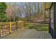 New, wooden back deck overlooks lush trees and a private backyard, offering relaxation and a nature view at 460 Stockwood Dr, Woodstock, GA 30188