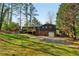 Home's back exterior showing a new deck, yard, driveway and an attached garage at 460 Stockwood Dr, Woodstock, GA 30188