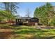 Large, fenced backyard and rear exterior of a home showcasing a new deck and an attached garage at 460 Stockwood Dr, Woodstock, GA 30188