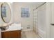 Bathroom featuring a shower, tub, a round mirror, and wood vanity at 460 Stockwood Dr, Woodstock, GA 30188