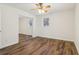 Bedroom featuring wood floors, neutral paint, and a mirrored closet at 460 Stockwood Dr, Woodstock, GA 30188