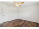 A cozy bedroom with wood-look flooring features a ceiling fan and white trim at 460 Stockwood Dr, Woodstock, GA 30188
